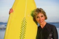 Lifestyle portrait of young beautiful and happy surfer woman holding yellow surf board smiling cheerful enjoying summer holid Royalty Free Stock Photo