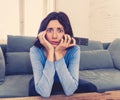 Portrait of a young woman looking scared and shocked watching TV. Human expressions and emotions Royalty Free Stock Photo