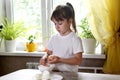 Lifestyle preschooler child girl cook food in the kitchen. development of fine motor skills in everyday life from scrap materials