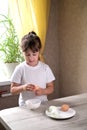 Lifestyle preschooler child girl cook food in the kitchen. development of fine motor skills in everyday life from scrap materials