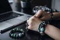 lifestyle shot of jewelry designer beading delicate bracelet in chic modern office