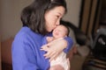 Lifestyle shot on young and happy Asian Chinese woman holding tenderly her adorable newborn baby girl in her arms in mother and Royalty Free Stock Photo