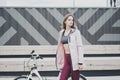 Lifestyle sport concepte. Portrait of young woman with vintage bike in city parking. Nature color toning for design Royalty Free Stock Photo