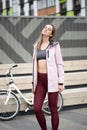 Lifestyle sport concepte. Portrait of young woman with vintage bike in city parking. Nature color toning for design Royalty Free Stock Photo