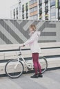 Lifestyle sport concepte. young woman with vintage bike in city parking. Nature color toning for design Royalty Free Stock Photo