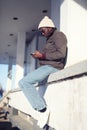 Lifestyle stylish young african man using smartphone in the city Royalty Free Stock Photo