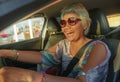 Lifestyle Summer portrait of middle aged happy and attractive classy Asian Indonesian woman driving car smiling cheerful and free Royalty Free Stock Photo