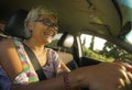 Lifestyle Summer portrait of middle aged happy and attractive classy Asian Indonesian woman driving left hand car smiling cheerful Royalty Free Stock Photo