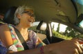 Lifestyle Summer portrait of middle aged happy and attractive classy Asian Indonesian woman driving left hand car smiling cheerful Royalty Free Stock Photo