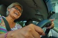 Lifestyle Summer portrait of middle aged happy and attractive classy Asian Indonesian woman driving left hand car smiling cheerful Royalty Free Stock Photo