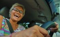 Lifestyle Summer portrait of middle aged happy and attractive classy Asian Indonesian woman driving left hand car smiling cheerful Royalty Free Stock Photo