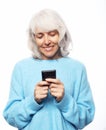 Lifestyle, tehnology and people concept: old woman wearing casual talking on cell phone over white background Royalty Free Stock Photo