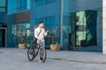 Lifestyle, transport, communication and people. Young man with bicycle and smartphone Royalty Free Stock Photo