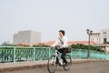 Lifestyle, transport and people concept - young man with headphones riding bicycle on city street Royalty Free Stock Photo