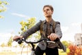 Teenage boy with earphones and bag riding bicycle Royalty Free Stock Photo