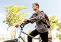 Teenage boy with earphones and bag riding bicycle Royalty Free Stock Photo