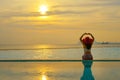 Lifestyle woman happy in big hat relaxing and freedom on the swimming pool near sea beach in the sunset, vacations and Holiday tip Royalty Free Stock Photo