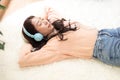 Lifestyle woman relaxing sleeping in living room. Happy girl lying down on comfortable pillows taking a nap Royalty Free Stock Photo