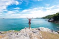 Lifestyle woman standing relax on a rock above the ocean