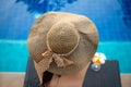 Lifestyle Woman in swimsuit relaxing and happy with cocktail on chaise-longue near swimming pool, summer day. Royalty Free Stock Photo