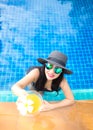 Lifestyle Woman in swimsuit relaxing and happy with cocktail on chaise-longue near swimming pool, summer day, select focus. Royalty Free Stock Photo