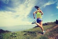 Lifestyle woman trail runner running on mountain peak