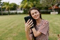 tree woman park grass cellphone palm nature happy lifestyle phone smiling blogger Royalty Free Stock Photo