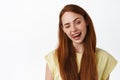 Lifestyle and women. Close up of redhead girl winking and showing tongue, stay positive, looking happy and upbeat