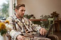 Lifestyle and workplace concept. Young handsome man in casual clothes, sitting in cafe with laptop, studying online Royalty Free Stock Photo