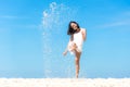 Lifestyle young asian woman relax kick sand and jumping on the beautiful beach