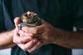 Lifetime savings, man holding a glass jar full of money coins