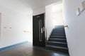 Lift door and staircase - white walls and bright window