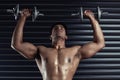 Lift it. a handsome young man working out with dumbbells. Royalty Free Stock Photo