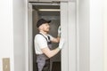 Lift machinist man repairing elevator fixing or adjusting mechanism