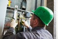 Lift machinist repairing elevator in lift shaft