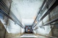 Lift machinist repairing elevator in lift shaft