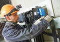 Lift machinist repairing elevator in lift shaft