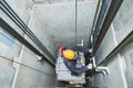 Lift machinist repairing elevator in lift shaft Royalty Free Stock Photo