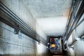 Lift machinist repairing elevator in lift shaft