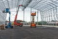 Lift with platform work in warehouse hangar construction field. Royalty Free Stock Photo