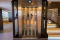 Lift with transparent glass doors in modern building Royalty Free Stock Photo