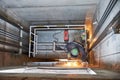 Lift worker welding elevator fasteners in lift shaft Royalty Free Stock Photo