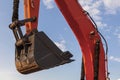 Lifting boom and excavator bucket against the sky Royalty Free Stock Photo