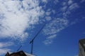 A lifting crane with a background of blue cloudy sky Royalty Free Stock Photo