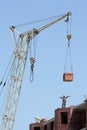 Lifting-crane lifts a bricks Royalty Free Stock Photo