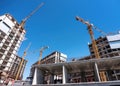 Lifting cranes at a construction site of new houses. Royalty Free Stock Photo