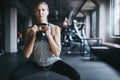 Lifting her spirits in the gym. an attractive young woman listening to music while working out with a kettle bell in the Royalty Free Stock Photo