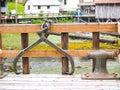 Lifting hook or caliper on shackle over railing and iron bollard