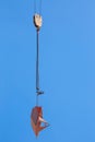 Lifting of metal pallet for dry bulk building materials on hoisting block with hook on steel chain on steel rope. Loading\