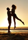 Lifting, silhouette and couple with sunset at beach, ocean and sea for affection, love and to relax. People, partners Royalty Free Stock Photo
